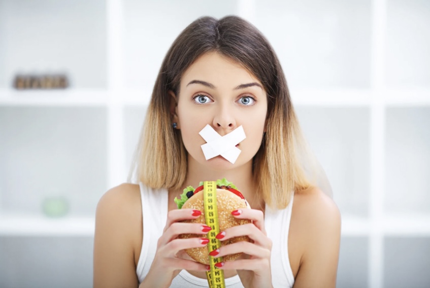 a woman restricting her food intake